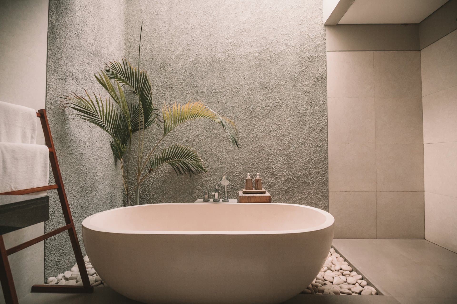 Freestanding bath in a stone-tiled spa bathroom
